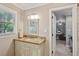 Bathroom featuring a vanity with granite countertops, stylish fixtures, and an open view to a bedroom at 194 Locust Nw St, Marietta, GA 30064
