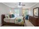 Charming bedroom featuring a bed with decorative pillows and a dresser with a mirror at 194 Locust Nw St, Marietta, GA 30064