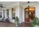 View of the covered front porch featuring ample seating and a decorative entrance at 194 Locust Nw St, Marietta, GA 30064