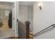 Hallway with a stairwell and iron railing, hardwood flooring, and a glimpse of the living space at 194 Locust Nw St, Marietta, GA 30064
