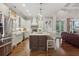 A bright, spacious kitchen with stainless steel appliances, an island with seating, and hardwood floors at 194 Locust Nw St, Marietta, GA 30064
