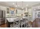An open kitchen features an island with seating, stainless steel appliances, and marble countertops at 194 Locust Nw St, Marietta, GA 30064