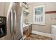 A well-appointed laundry room with stainless steel appliances, shelving, and an organized design at 194 Locust Nw St, Marietta, GA 30064