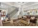 Inviting living room featuring hardwood floors, an elegant staircase, and open access to the modern kitchen at 194 Locust Nw St, Marietta, GA 30064