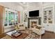 Cozy living room with fireplace, built-in bookshelves and large windows at 194 Locust Nw St, Marietta, GA 30064