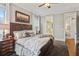 Comfortable main bedroom with a dark wood bed frame, hardwood floors, and ensuite bathroom access at 194 Locust Nw St, Marietta, GA 30064