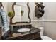 Elegant powder room with decorative mirror, dark vanity, granite countertop, and modern fixtures at 194 Locust Nw St, Marietta, GA 30064