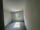 Bright bedroom featuring soft carpeting, a window, and neutral paint at 20 Emerald Ln, Covington, GA 30014
