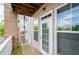 Balcony with a door and windows featuring light colored siding and a brick column at 1955 Nocturne Dr # 3206, Alpharetta, GA 30009