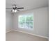 This bedroom features a ceiling fan and large window at 1955 Nocturne Dr # 3206, Alpharetta, GA 30009