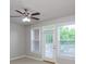 Bright living room featuring a ceiling fan, windows, and a door to the outside at 1955 Nocturne Dr # 3206, Alpharetta, GA 30009