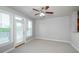 Living room featuring windows and a door leading to the outside, with a ceiling fan at 1955 Nocturne Dr # 3206, Alpharetta, GA 30009