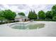 Aerial view of community pool undergoing cleaning and surrounded by lush landscaping at 1955 Nocturne Dr # 3206, Alpharetta, GA 30009