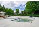 Community pool undergoing cleaning and surrounded by lush green landscaping at 1955 Nocturne Dr # 3206, Alpharetta, GA 30009