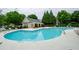 Community pool with lounging area and nearby clubhouse at 1955 Nocturne Dr # 3206, Alpharetta, GA 30009