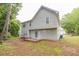 View of the backyard and the exterior wall of the house that features siding and multiple windows at 3514 Willgrove Way, Duluth, GA 30096