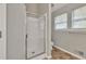 Bright bathroom with a glass-enclosed shower and a large window at 3514 Willgrove Way, Duluth, GA 30096