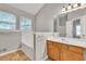 Well-lit bathroom with a tub, large mirror, and traditional vanity at 3514 Willgrove Way, Duluth, GA 30096