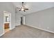 Expansive bedroom with connecting ensuite, featuring neutral carpet, ceiling fan, and natural light at 3514 Willgrove Way, Duluth, GA 30096