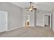 Generous bedroom with neutral carpeting, multiple doors, and a ceiling fan at 3514 Willgrove Way, Duluth, GA 30096