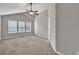 Spacious bedroom with neutral carpet, large windows, and a ceiling fan at 3514 Willgrove Way, Duluth, GA 30096