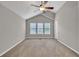 Bright bedroom featuring carpet, large windows for natural light, and a ceiling fan at 3514 Willgrove Way, Duluth, GA 30096