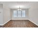 Dining room featuring wood floors, natural light and a modern chandelier at 3514 Willgrove Way, Duluth, GA 30096
