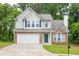 Charming two-story home with stone accents, a well-manicured lawn, and an attached two-car garage at 3514 Willgrove Way, Duluth, GA 30096