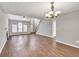 Open-concept living room featuring wood floors, a stairway, and lots of natural light from large windows at 3514 Willgrove Way, Duluth, GA 30096