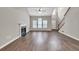 Open-concept living room featuring wood floors, a fireplace, a stairway, and lots of natural light at 3514 Willgrove Way, Duluth, GA 30096