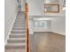 Open-concept living room featuring wood floors, a stairway, and lots of natural light from large windows at 3514 Willgrove Way, Duluth, GA 30096