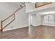Living room featuring wood floors, a stairway, and lots of natural light from large windows at 3514 Willgrove Way, Duluth, GA 30096