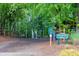 Community playground nestled in a wooded area with play equipment and seating at 3514 Willgrove Way, Duluth, GA 30096