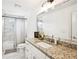 Clean bathroom featuring marble tile, a shower/bath, a single sink, and vanity mirror at 3991 Perry Pass, Lithonia, GA 30038