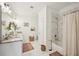 Bright bathroom featuring double sinks, white marble, granite countertops, and a bathtub shower at 3991 Perry Pass, Lithonia, GA 30038
