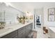 Bathroom features a large vanity with double sinks, marble countertop, and decorative artwork at 3991 Perry Pass, Lithonia, GA 30038