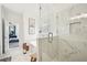 Bright bathroom showcasing a glass enclosed shower, tub, and marble flooring at 3991 Perry Pass, Lithonia, GA 30038