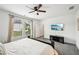 Comfortable bedroom featuring a ceiling fan, media center, and a window with natural light at 3991 Perry Pass, Lithonia, GA 30038