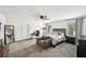 Bright bedroom features a ceiling fan, work space, and cozy sitting area at 3991 Perry Pass, Lithonia, GA 30038