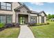 Charming front entrance with a modern door, wreath accents, and lush landscaping at 3991 Perry Pass, Lithonia, GA 30038