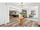 Hallway featuring hardwood flooring leading into a living room with a dark sofa and decorative fireplace at 3991 Perry Pass, Lithonia, GA 30038