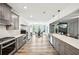 Gourmet kitchen with gray cabinets, stainless steel appliances, quartz countertops, and an open layout at 3991 Perry Pass, Lithonia, GA 30038