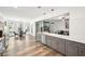 Open concept kitchen with gray cabinets, stainless steel appliances, and a view to an adjacent breakfast nook at 3991 Perry Pass, Lithonia, GA 30038