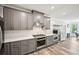 Modern kitchen with gray cabinets, quartz counters, stainless steel appliances and an open concept design at 3991 Perry Pass, Lithonia, GA 30038