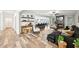Open-concept living room with a fireplace, modern furniture, and access to the kitchen at 3991 Perry Pass, Lithonia, GA 30038