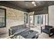 Inviting covered outdoor living space with brick accents, comfortable seating, and a ceiling fan at 3991 Perry Pass, Lithonia, GA 30038