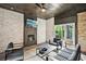 Cozy covered outdoor living area with a fireplace, TV, ceiling fan, and comfortable seating at 3991 Perry Pass, Lithonia, GA 30038