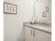 Bright powder room featuring granite countertop, framed artwork, and chrome fixtures at 3991 Perry Pass, Lithonia, GA 30038
