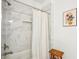 Clean shower showcasing marble tile, a shower caddy, and adjustable handheld shower features at 3991 Perry Pass, Lithonia, GA 30038