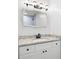 Bathroom with new vanity, granite countertop, light fixture, and a large decorative mirror at 705 Country Park Se Dr, Smyrna, GA 30080